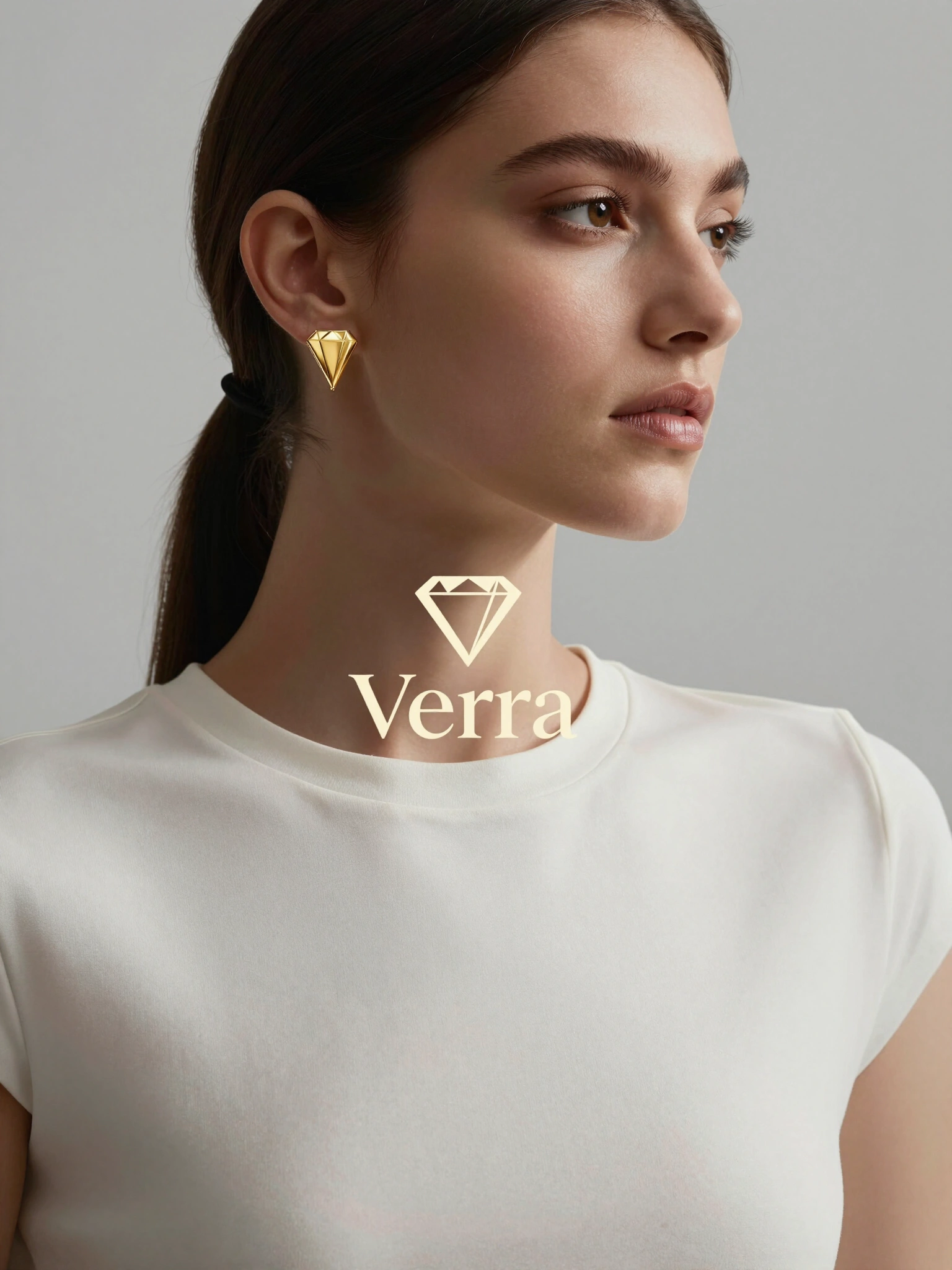 Elegant woman wearing Verra gold earrings and minimalist white top