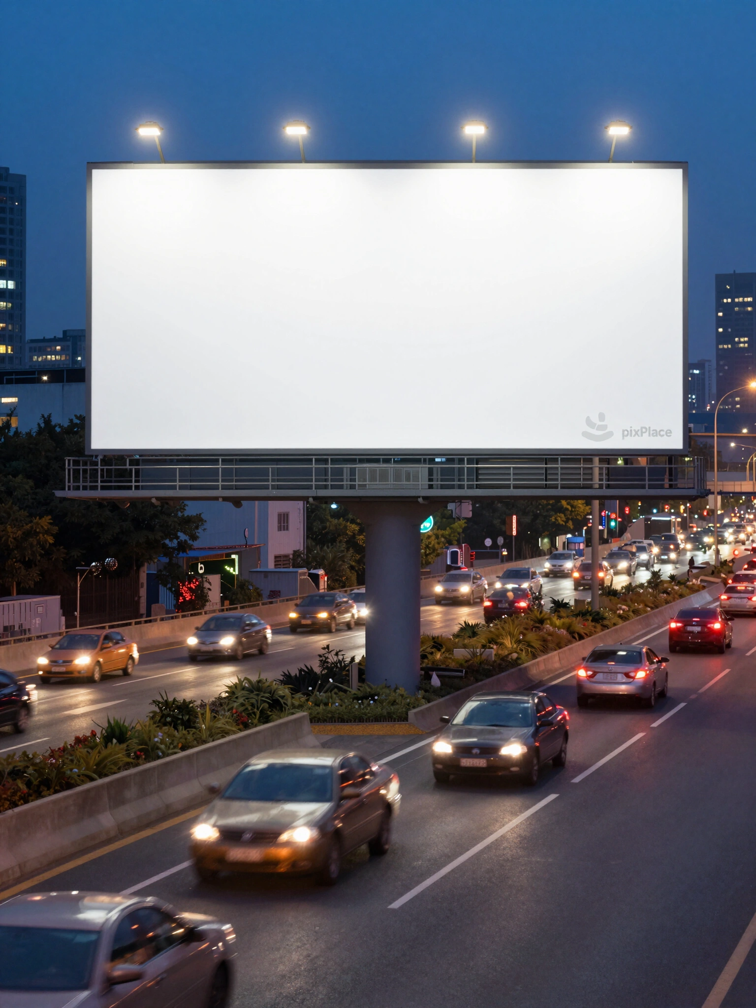 A large blank billboard on a highway at dusk with city lights and traffic
